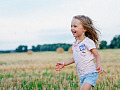 young girl running joyfully in a meadow