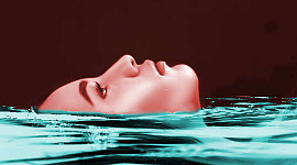 face of woman floating in water