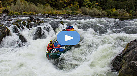 group of people riding the rapids in a raft