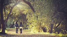 two girls walking on a path