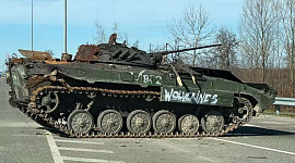abandoned Russian tank tagged with the word “Wolverines”