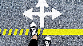 two feet at a line with arrows in three directions... which way to go?