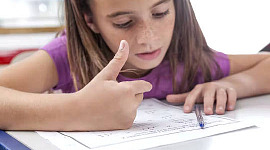 a child doing math homework and counting on her fingers