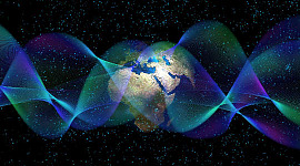grafika przedstawiająca planetę Ziemię oraz fale i cząstki fizyki kwantowej