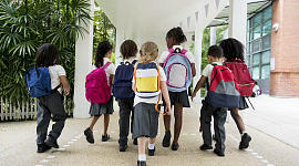 sekelompok anak kecil berjalan ke sekolah