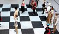 shakkilauta, jossa ihmiset ovat shakkinappuloita